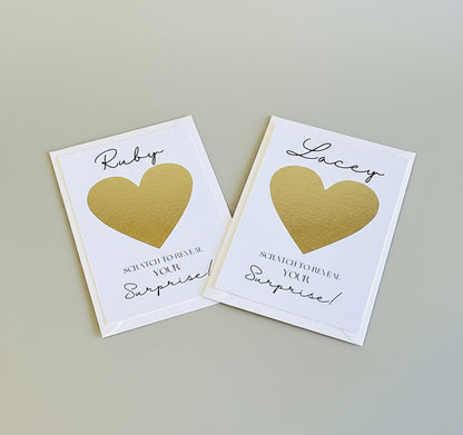Two scratch cards with gold hearts and text